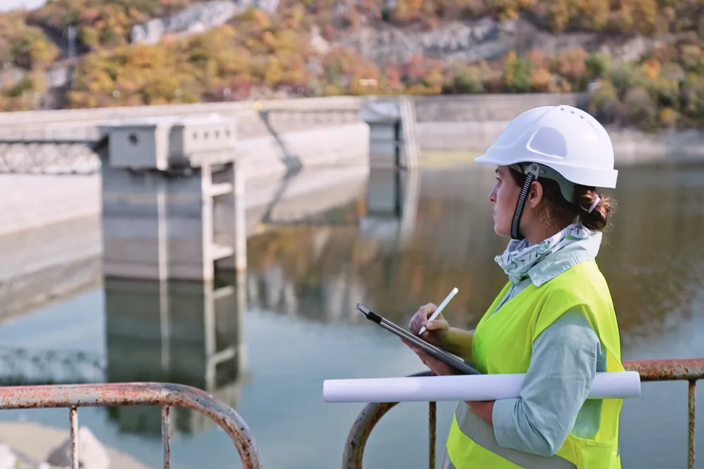 Asian man in high visibility clothing and a hard hat